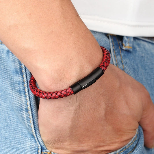 Red braided bracelet on a wrist with a blurred background
