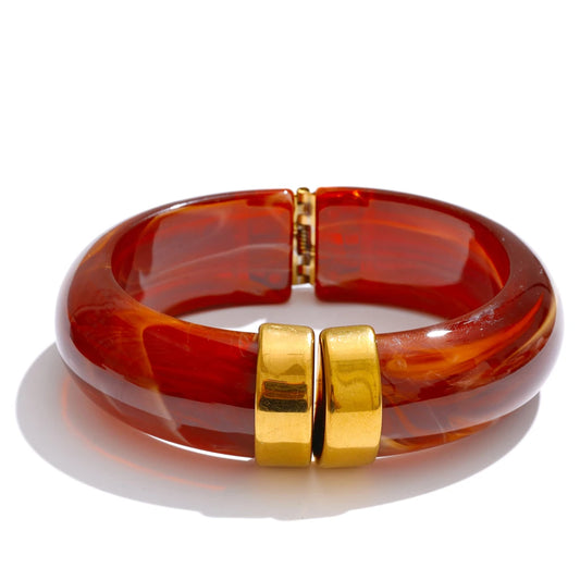 Red-brown bracelet with gold clasp on a white background
