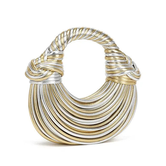 Gold and silver crescent shape handbag on a white background