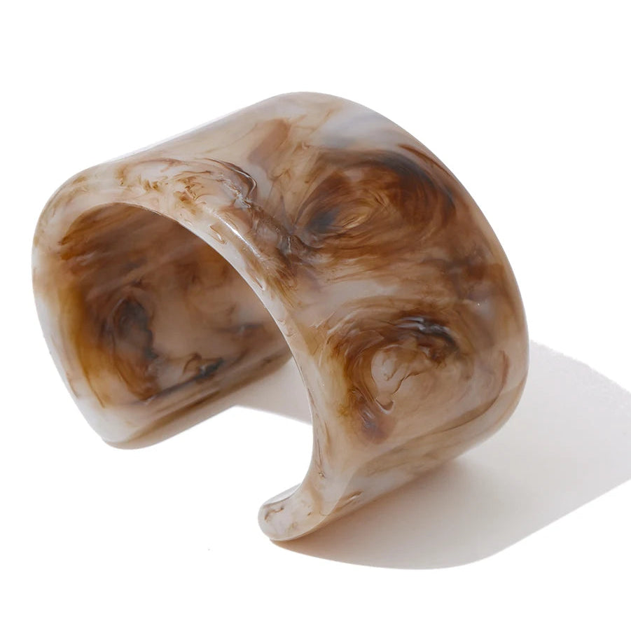 Marbled brown and beige bracelet on a white background