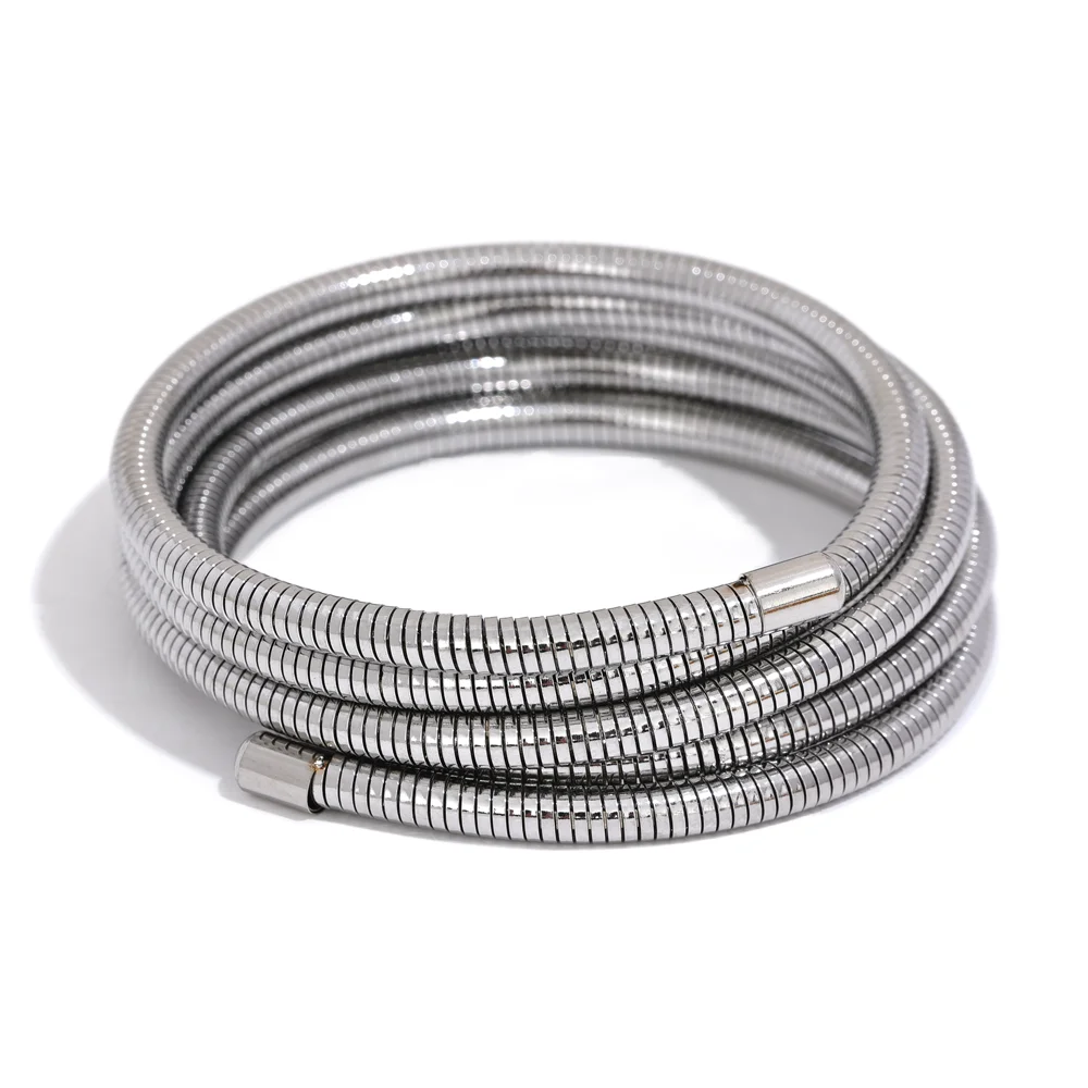 Coiled metal wrap bracelet on a white background