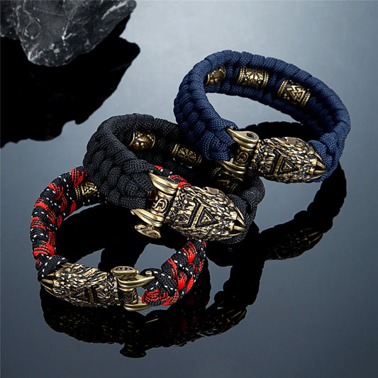 Three braided bracelets with decorative clasps on a reflective surface