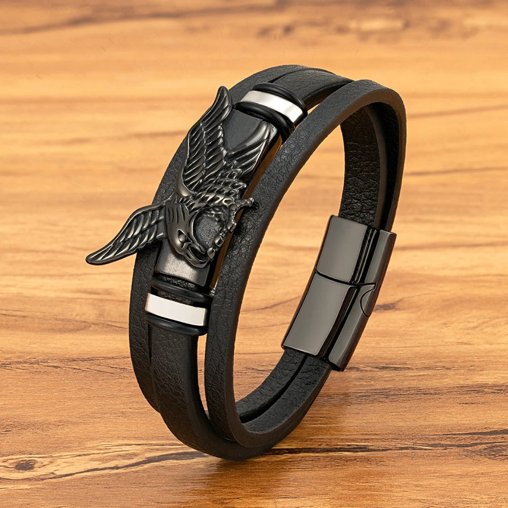 Black leather bracelet with an eagle emblem on a wooden surface