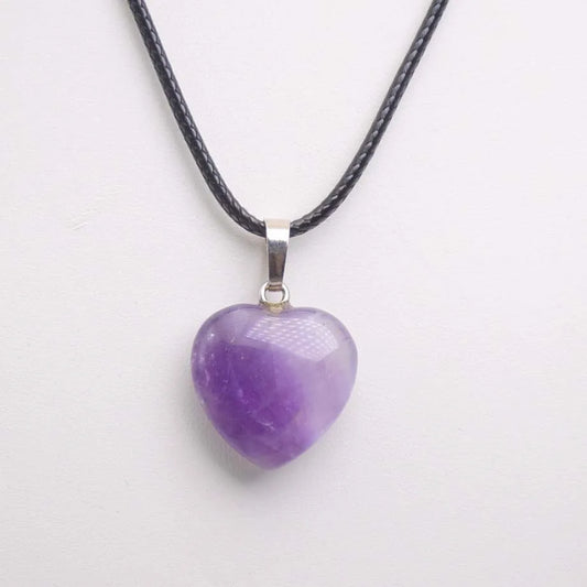 Purple heart-shaped pendant on a black cord against a white background