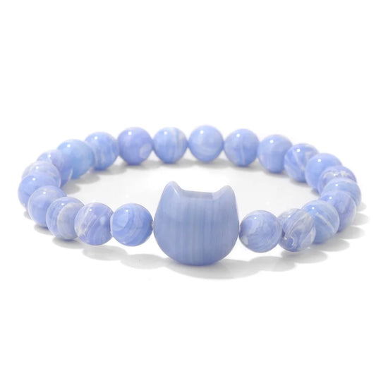 Blue beaded bracelet with a cat-shaped charm on a white background