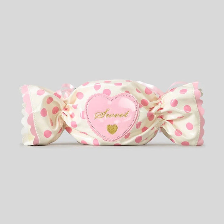 Candy shaped bag with polka dot and heart-shaped label on a grey background