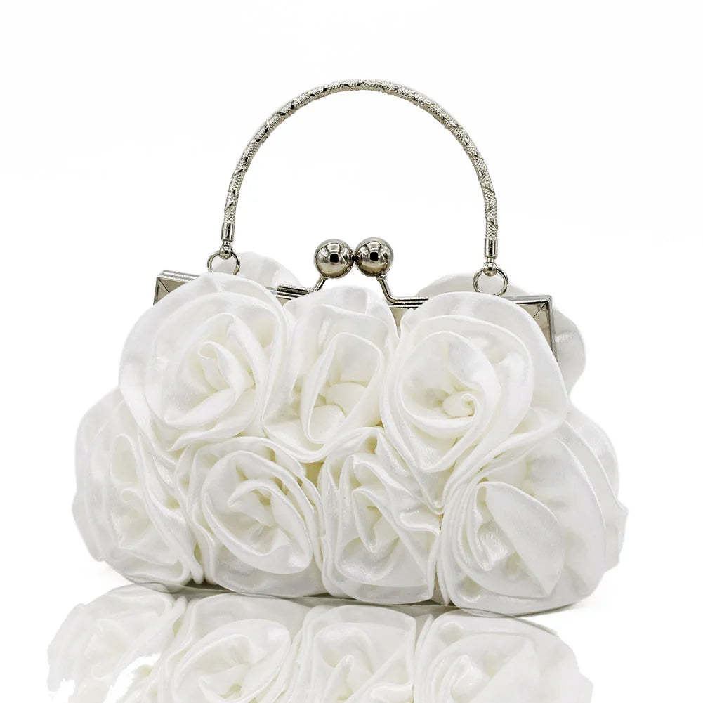 White floral clutch bag with silver frame on a white background