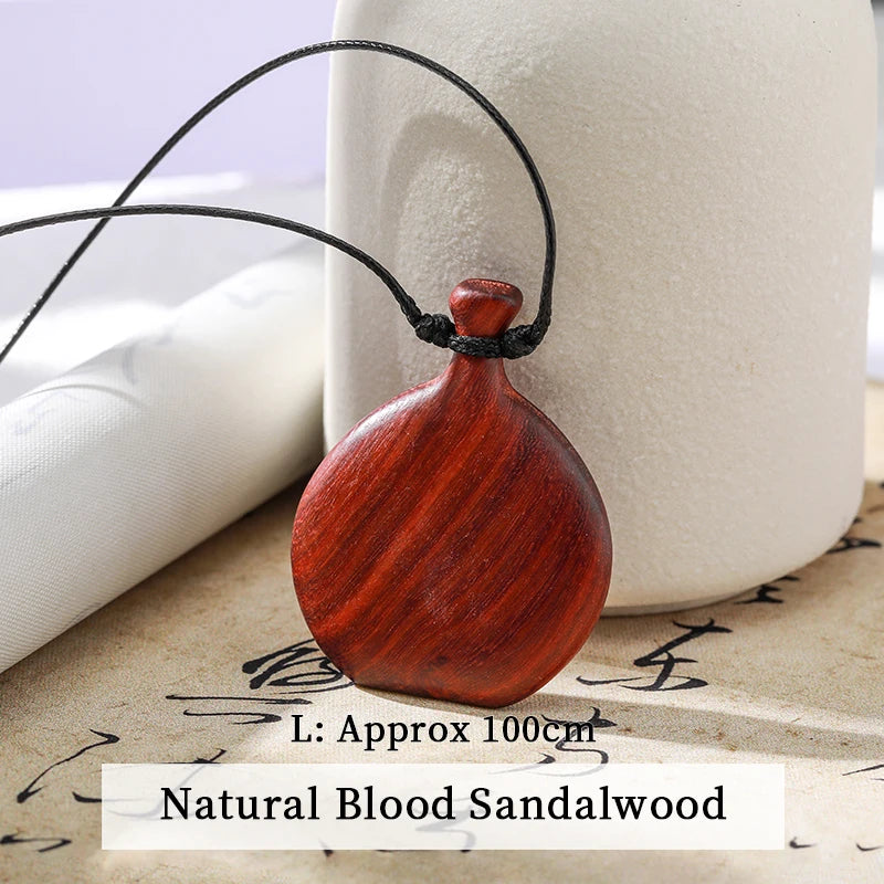 Wooden pendant on a string with a white background
