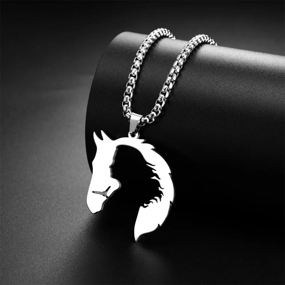Silver horse head pendant on a chain against a dark background