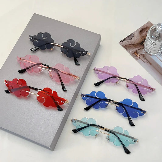 Colourful sunglasses with cloud-shaped lenses on a grey surface.