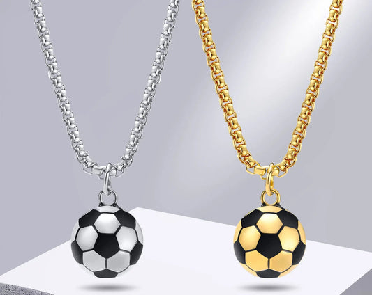 Two necklaces with soccer ball pendants, one gold and one silver, on a gray background.