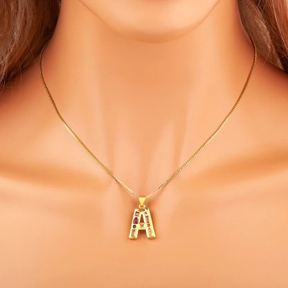 Gold necklace with a letter 'A' pendant on a person's neck.