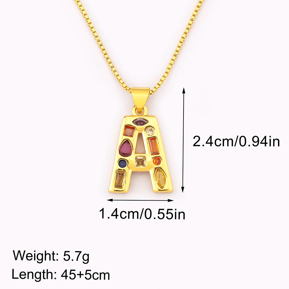 Gold necklace with a colorful 'A' pendant and measurements on a white background