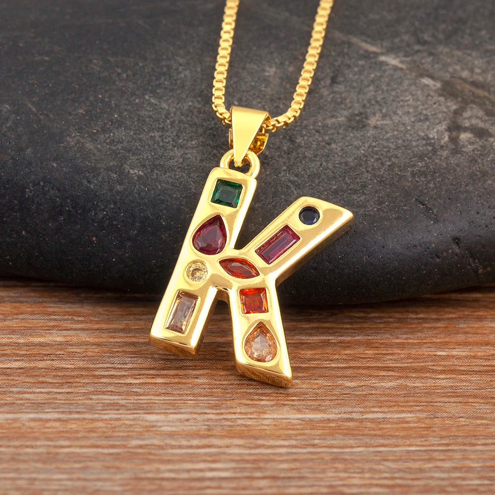 Gold pendant with colourful gemstones on a wooden surface