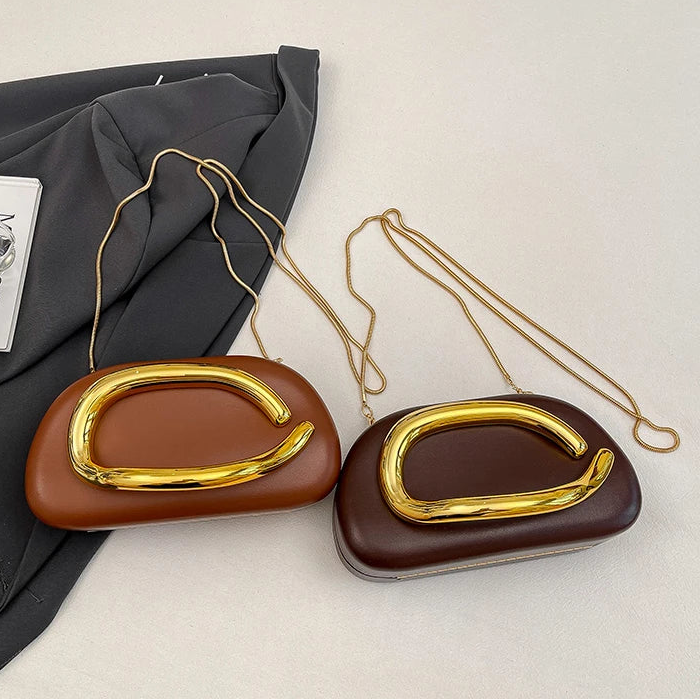 Two brown handbags with gold handles on a light grey background