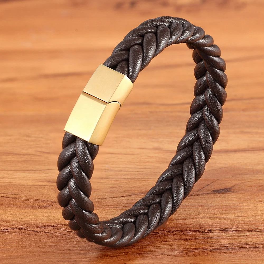 Brown braided leather bracelet with a gold clasp on a wooden surface