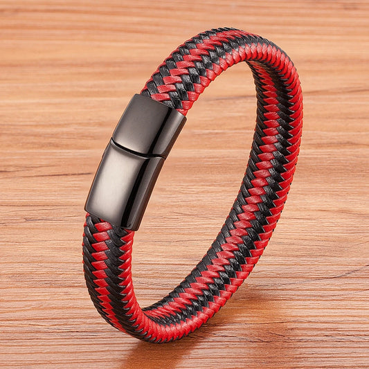 Red and black braided bracelet with a black clasp on a wooden surface
