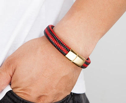 Bracelet with red and black pattern on wrist against a neutral background