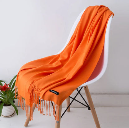 Orange scarf draped over a chair with a white background