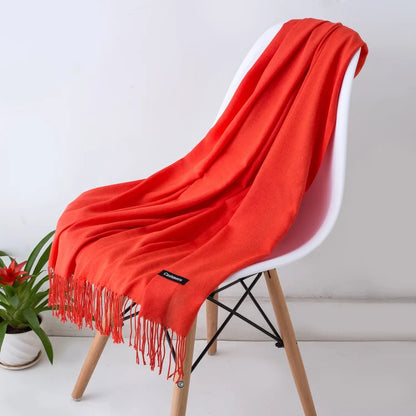 Red scarf draped over a white chair with a plant in the background