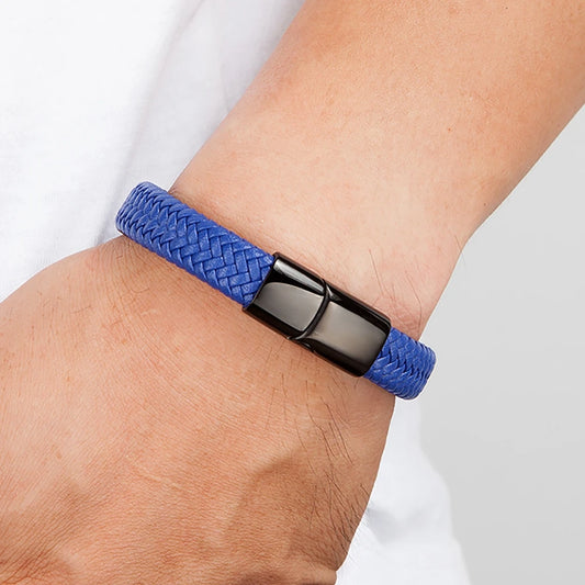 Blue braided bracelet with a black clasp on a wrist against a white background
