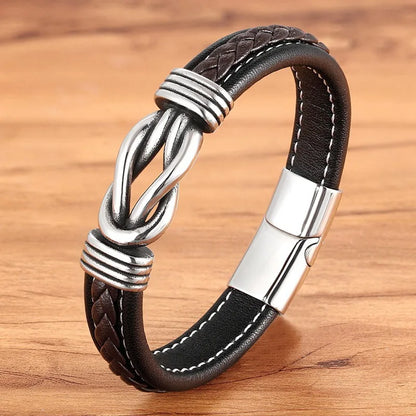 Brown leather bracelet with silver knot design on a wooden surface