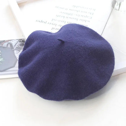 Navy blue beret on a white surface with a magazine underneath