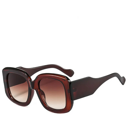 Brown sunglasses with a gradient lens on a white background
