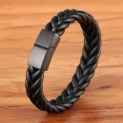 Black braided leather bracelet with a metallic clasp on a wooden surface