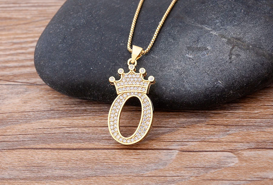 Gold necklace with a decorative pendant on a wooden surface