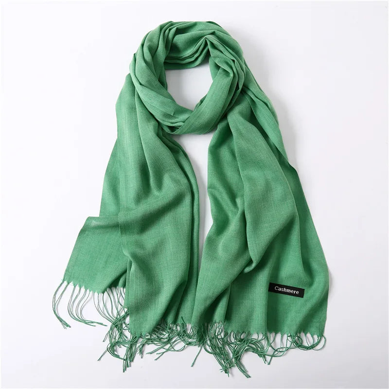 Green scarf with fringes on a white background