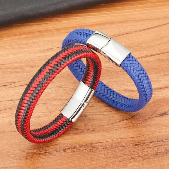 Two braided keychains, one red and black, the other blue, on a wooden surface.