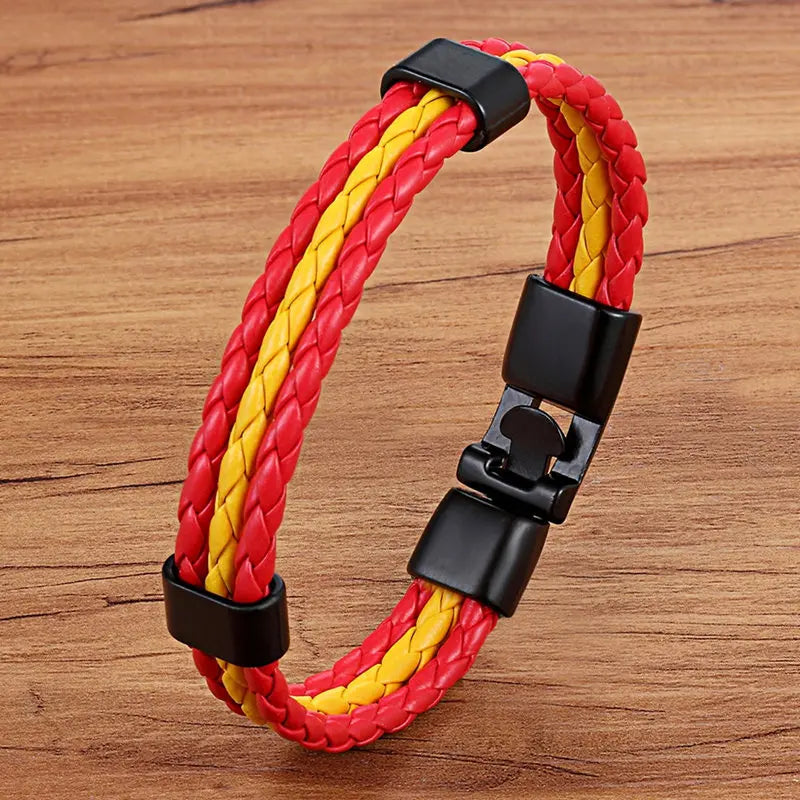 Red and yellow braided bracelet with black clasp on a wooden surface