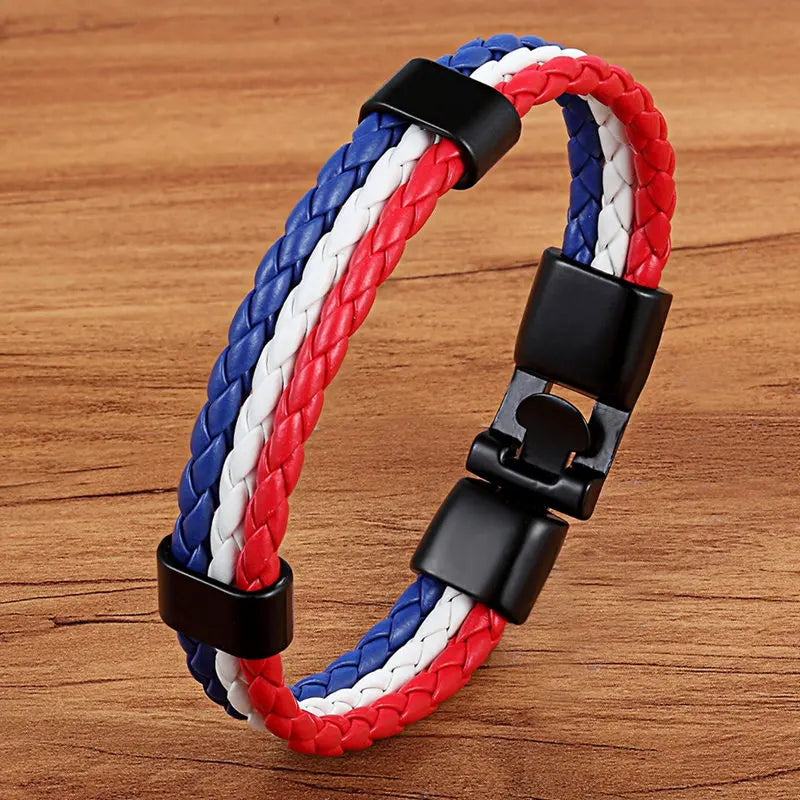 Bracelet with red, white, and blue braided design on a wooden surface