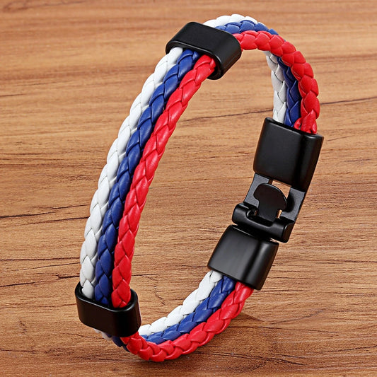 Bracelet with red, white, and blue braided design on a wooden surface