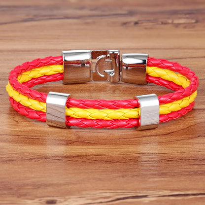 Bracelet with red and yellow braided design on a wooden surface