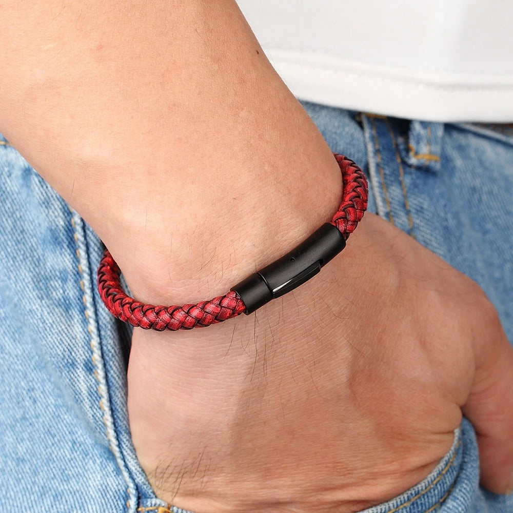 Red braided bracelet on a wrist with a blurred background