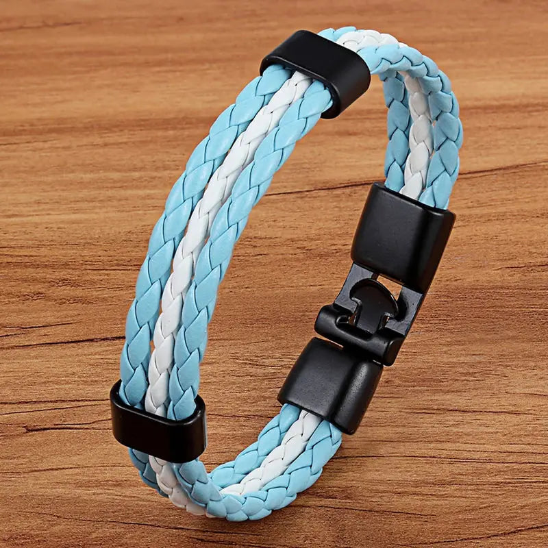Braided blue and white bracelet with black clasp on a wooden surface