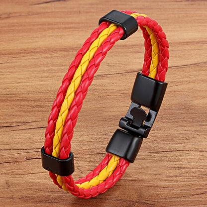 Red and yellow braided bracelet with black clasp on a wooden surface