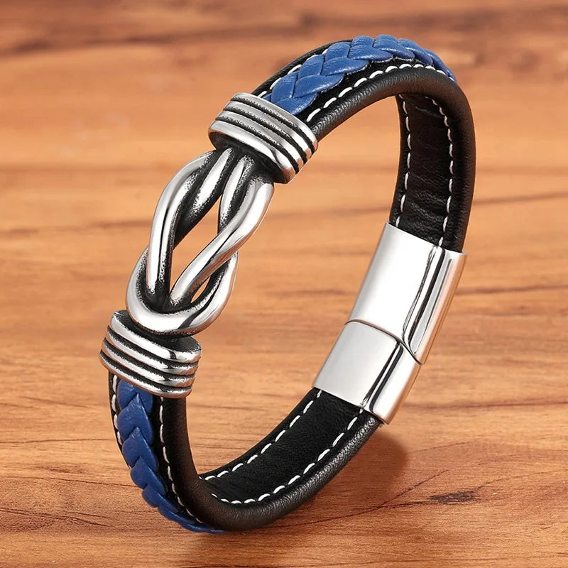 Black and blue braided leather bracelet with silver clasp on a wooden surface