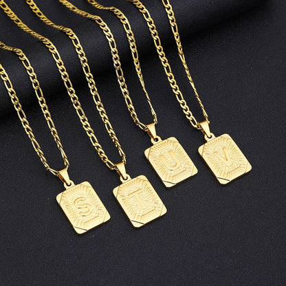 Gold necklaces with square pendants on a black background