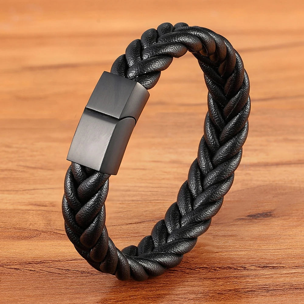 Black braided leather bracelet with a metallic clasp on a wooden surface