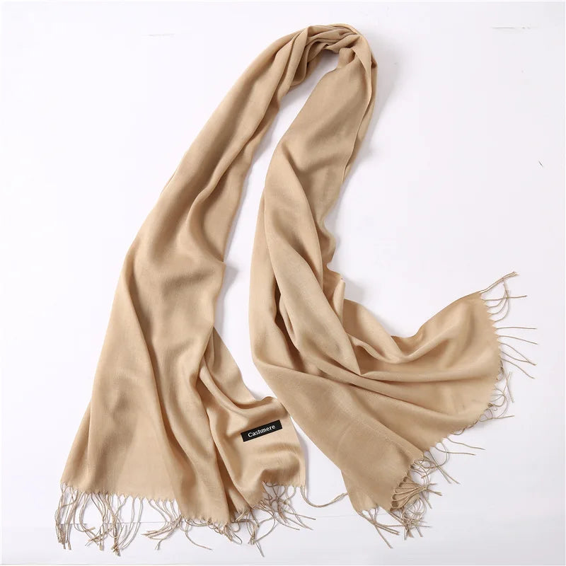 Beige scarf with fringes on a white background