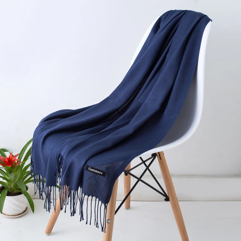 Navy blue scarf draped over a white chair with a plant in the background