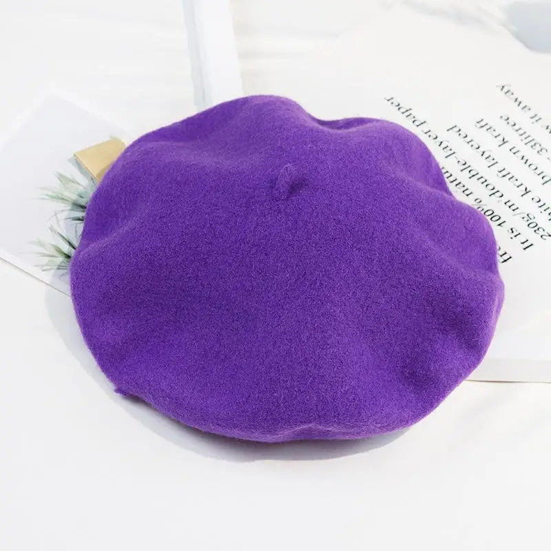 Purple beret on a white surface with text