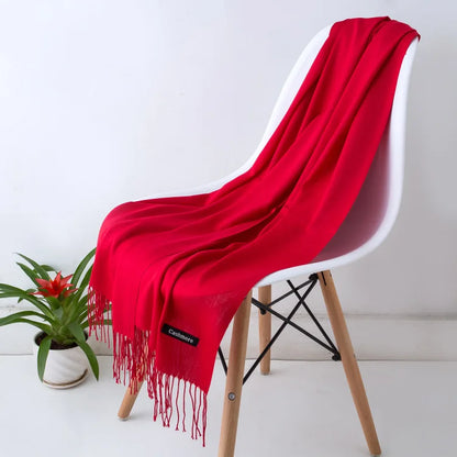 Red scarf draped over a white chair with a plant in the background