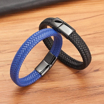 Two braided bracelets, one blue and one black, on a wooden surface.