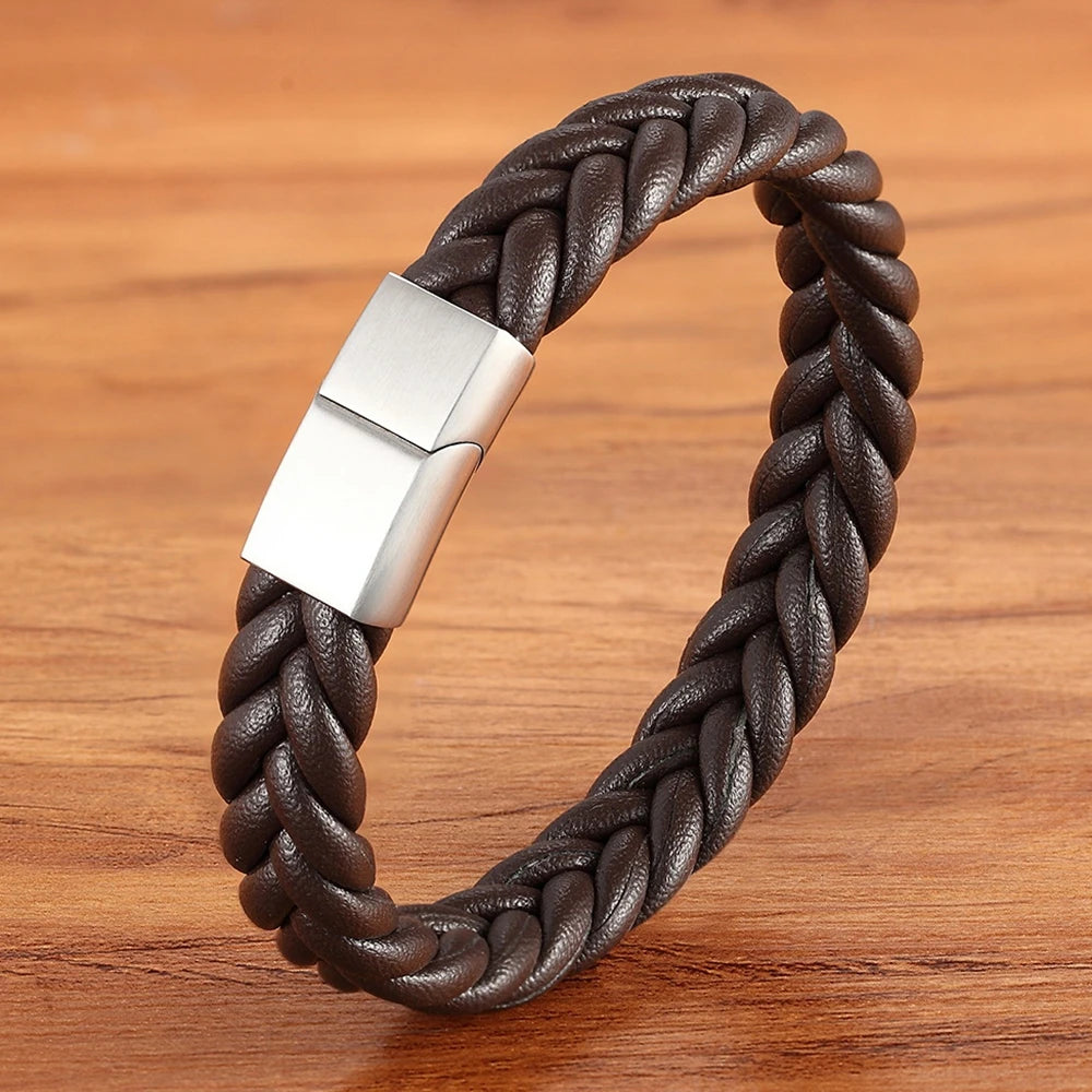 Brown braided leather bracelet with a silver clasp on a wooden surface