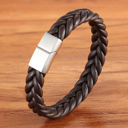 Brown braided leather bracelet with a silver clasp on a wooden surface