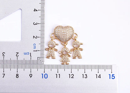 Jewelry charm with heart and child charms on a ruler for scale